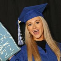 student poses with foam finger